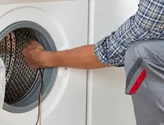 Dryer repair technician diagnosing and servicing a clothes dryer in Charleston, SC