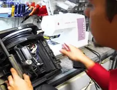 Vacuum repair technician servicing internal components on a workbench in Charleston, SC