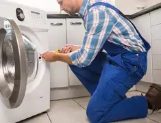Washing machine repair technician servicing a front-load washer in Charleston, SC