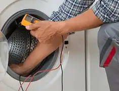 Washing machine repair technician testing a front-load washer with diagnostic tools in Charleston, SC
